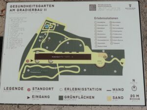 A photo of an outdoor orientation map displayed on a tactile plaque. The map presents the layout of the Gesundheitsgarten am Gradierbau II, in the town of Bad Nauheim.