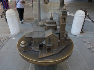 The first image shows a brass tactile model of the Basilica di Santa Maria Maggiore in Bergamo.
