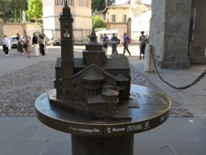 The second photo shows the right side of the tactile model, where the tower is fully visible.