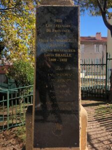 The third photo features the marble stone beneath the bust of Louis Braille. It bears the following inscription in French, in print, and in Braille: