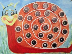 The image shows an illustration of a cartoon-style red-orange snail. Its spiral shell is decorated with black tiles, each displaying a letter of the alphabet, arranged sequentially from A to Z.