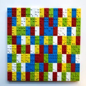 The gray LEGO plate has LEGO bricks with Braille dots on them.
1st row:
Y Y Y A Y Y Y A Y A Y
2nd row:
L M N A Q P A S R T A
3rd row:
B E C A C D F A J A H
4th row:
A row of 11 A's. The 2nd and 6th A's are upside down.