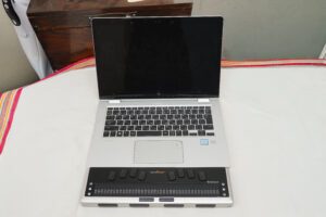 Simple ordinary layout of a laptop and a braille display